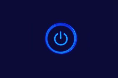 Close-up of illuminated blue over black background