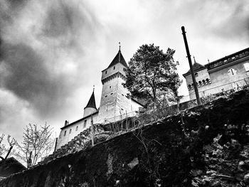 Low angle view of building against cloudy sky