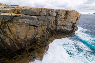 Rock formations in sea against sky