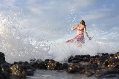 Woman splashing water in sea