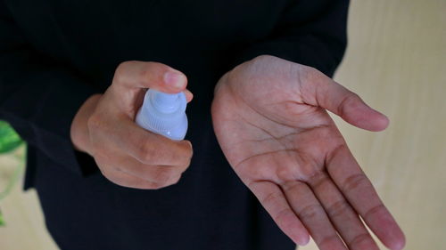 Spray disinfectant liquid into the hands, to kill the virus