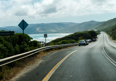 Road amidst mountains against sky