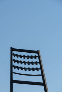 Low angle view of stadium light against clear blue sky