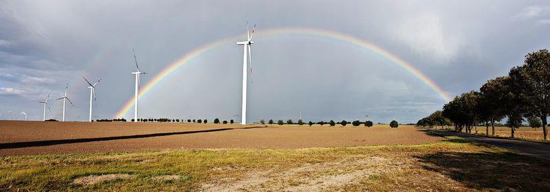 Rainbow over landscape against sky