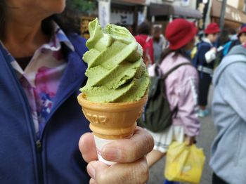 Midsection of woman holding ice cream