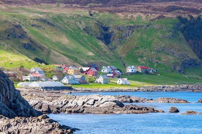 Scenic view of landscape and houses against mountain