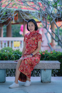 Portrait of woman sitting outdoors