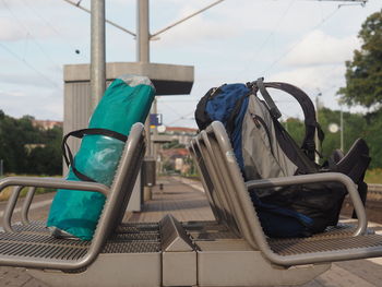 Close-up of bags left unattended on benches in train station platform