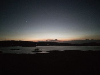 View of calm lake against mountain range