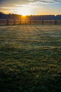 Scenic view of field against sky during sunset