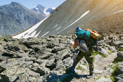 Man standing on rock in mountains