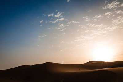 Scenic view of desert against sky during sunset