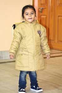 Portrait of smiling girl standing on floor