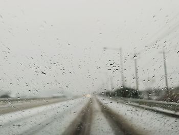 Road seen through wet car window