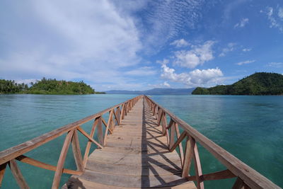 View of jetty in sea against sky