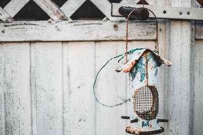 Close-up of old lamp hanging on wall