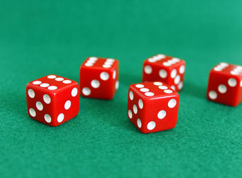 Close-up of red dice on green table