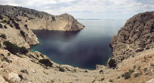 Scenic view of rocks and sea against sky