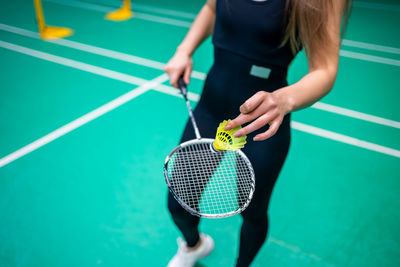 Midsection of woman playing tennis