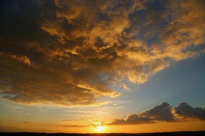 Scenic view of dramatic sky at sunset