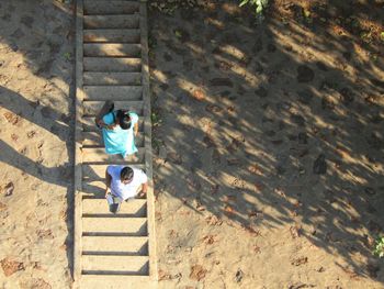 High angle view of man walking on staircase