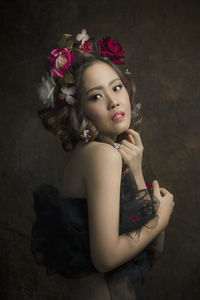 Portrait of beautiful woman with red flower