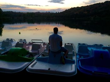 Boats in lake at sunset