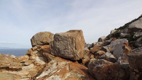 Rock formation on a beach against the sky - tangier morocco