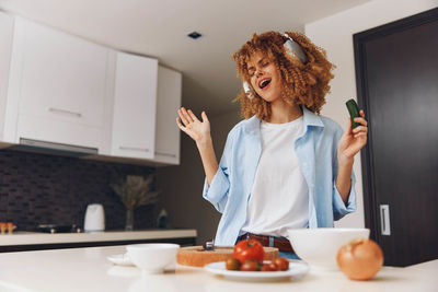 Portrait of young woman sitting at home