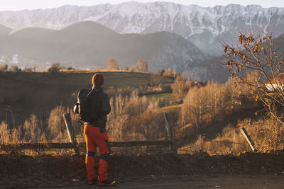 Rear view of woman walking on mountain