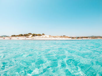 Scenic view of sea against clear blue sky