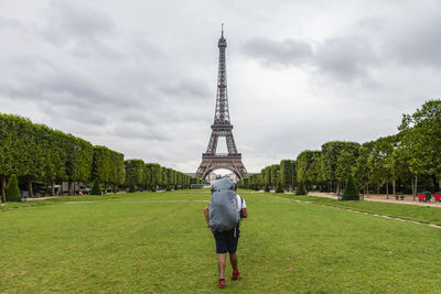 Rear view of woman against cloudy sky