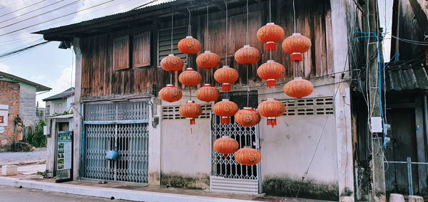 Lanterns hanging on house by building