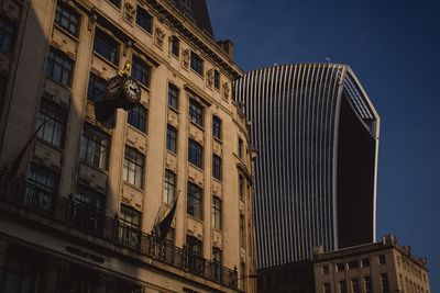 Low angle view of buildings against sky in city