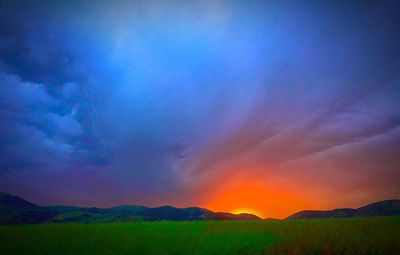 Scenic view of landscape against sky at sunset