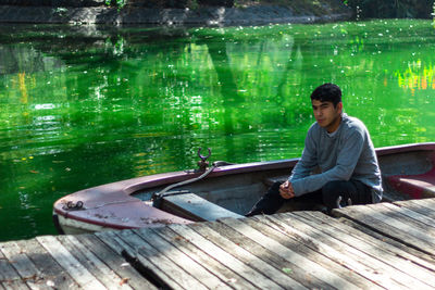 Man sitting in boat on lake