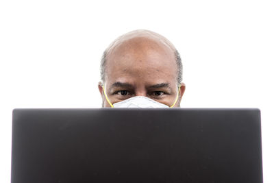 Portrait of man using smart phone against white background