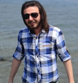 Portrait of young man standing in sea