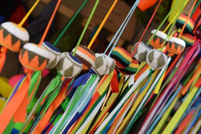 Tilt shot of colorful toys hanging at market stall