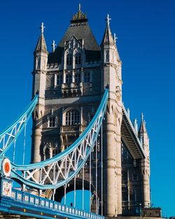 Low angle view of bridge against buildings