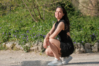 Portrait of young woman standing on road