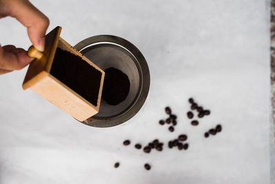 High angle view of hand holding coffee cup