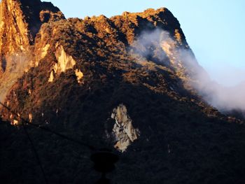 Close-up of volcanic mountain against sky