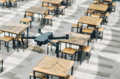 Close-up of drone over tables and chairs