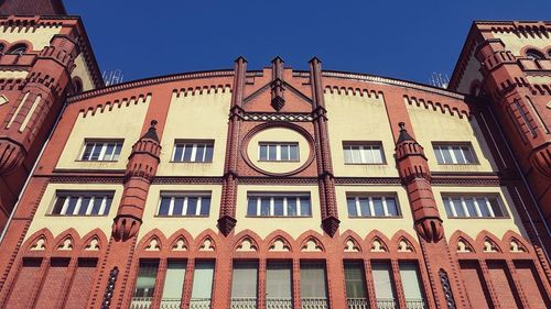 Low angle view of building against clear blue sky