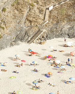 High angle view of people relaxing on beach