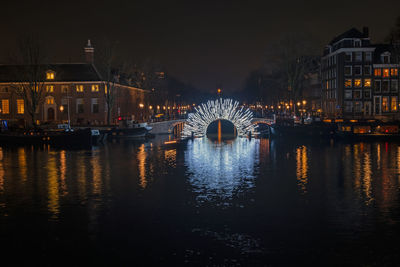 City scenic from amsterdam at the amstel in the netherlands by night