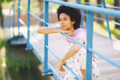 Young woman looking through railing