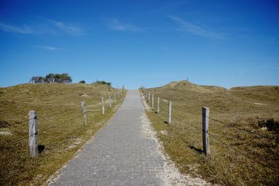 Scenic view of landscape against blue sky