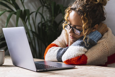 Young woman using laptop at home